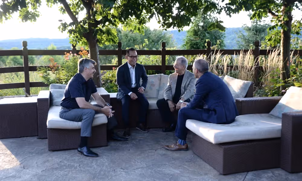 Group of men chatting in the Che'f Garden